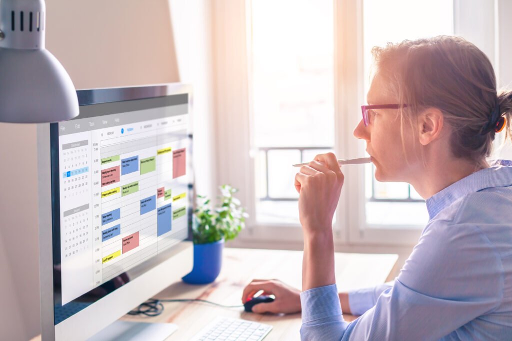 A woman reviews plans at her computer